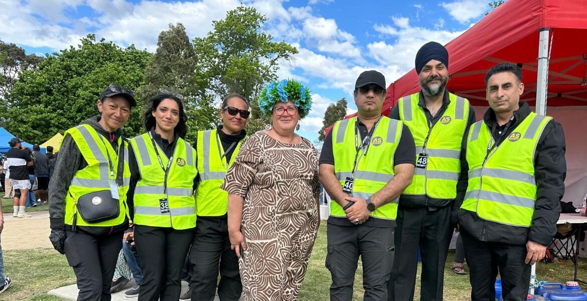 Group of AS Security personnel in high-visibility vests at an outdoor event in Melbourne, showcasing professional security services.